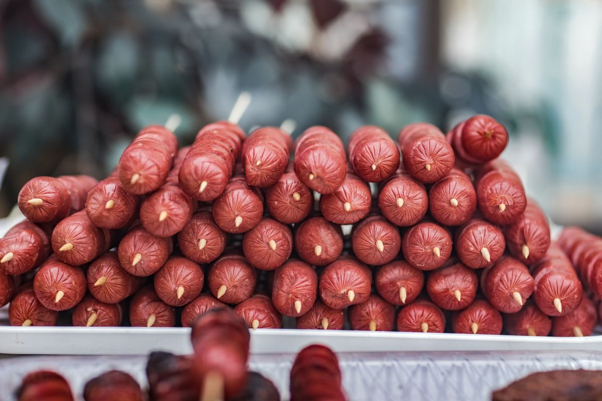 Rows of prepared sausage at a meat counter